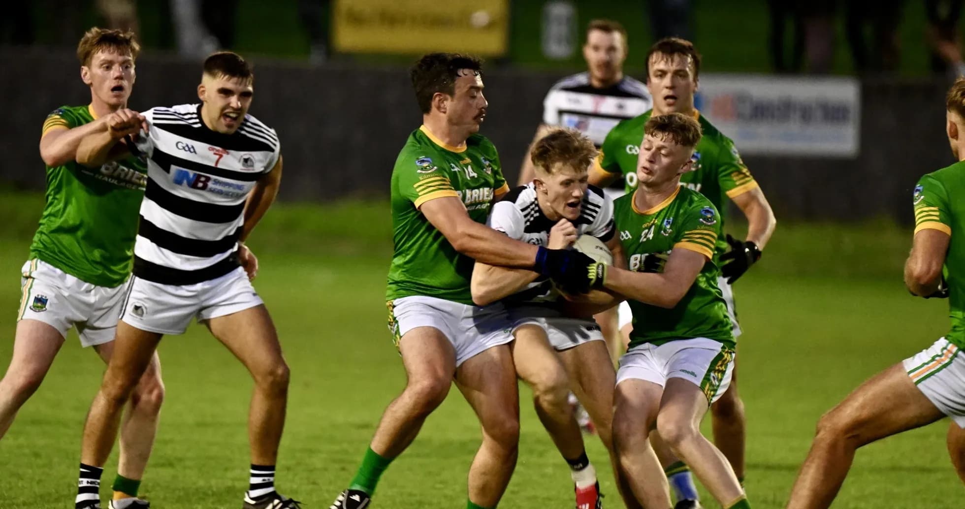 Players from two teams contesting for the ball