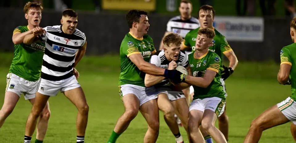 Players from two teams contesting for the ball
