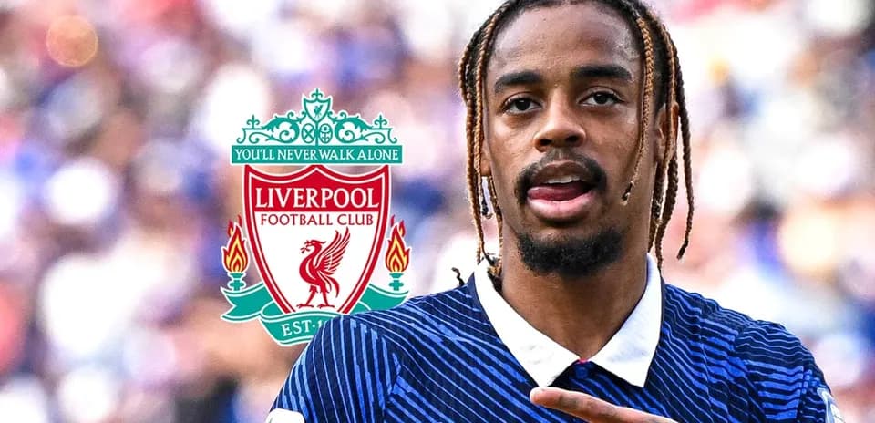 Player celebrating with Liverpool FC logo in background