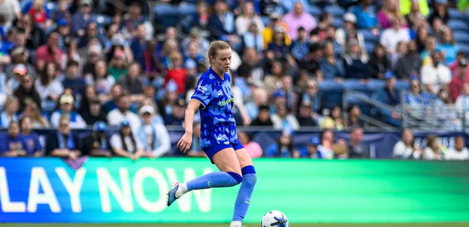 Player kicking ball during Seattle Reign FC match