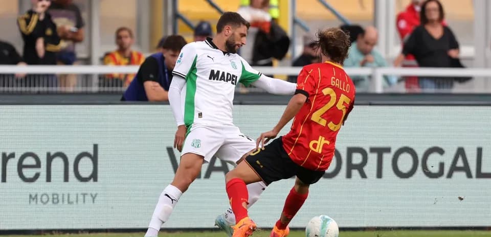 Sassuolo player tackling Lecce player during match