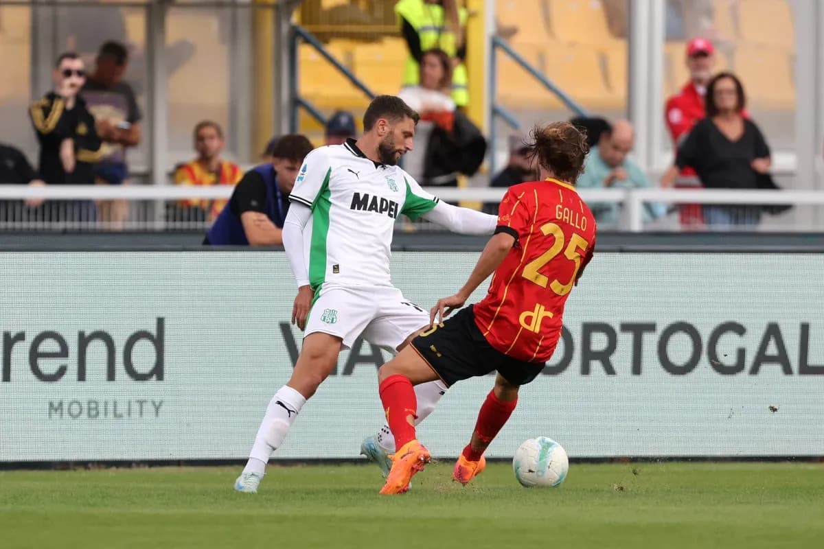 Sassuolo player tackling Lecce player during match