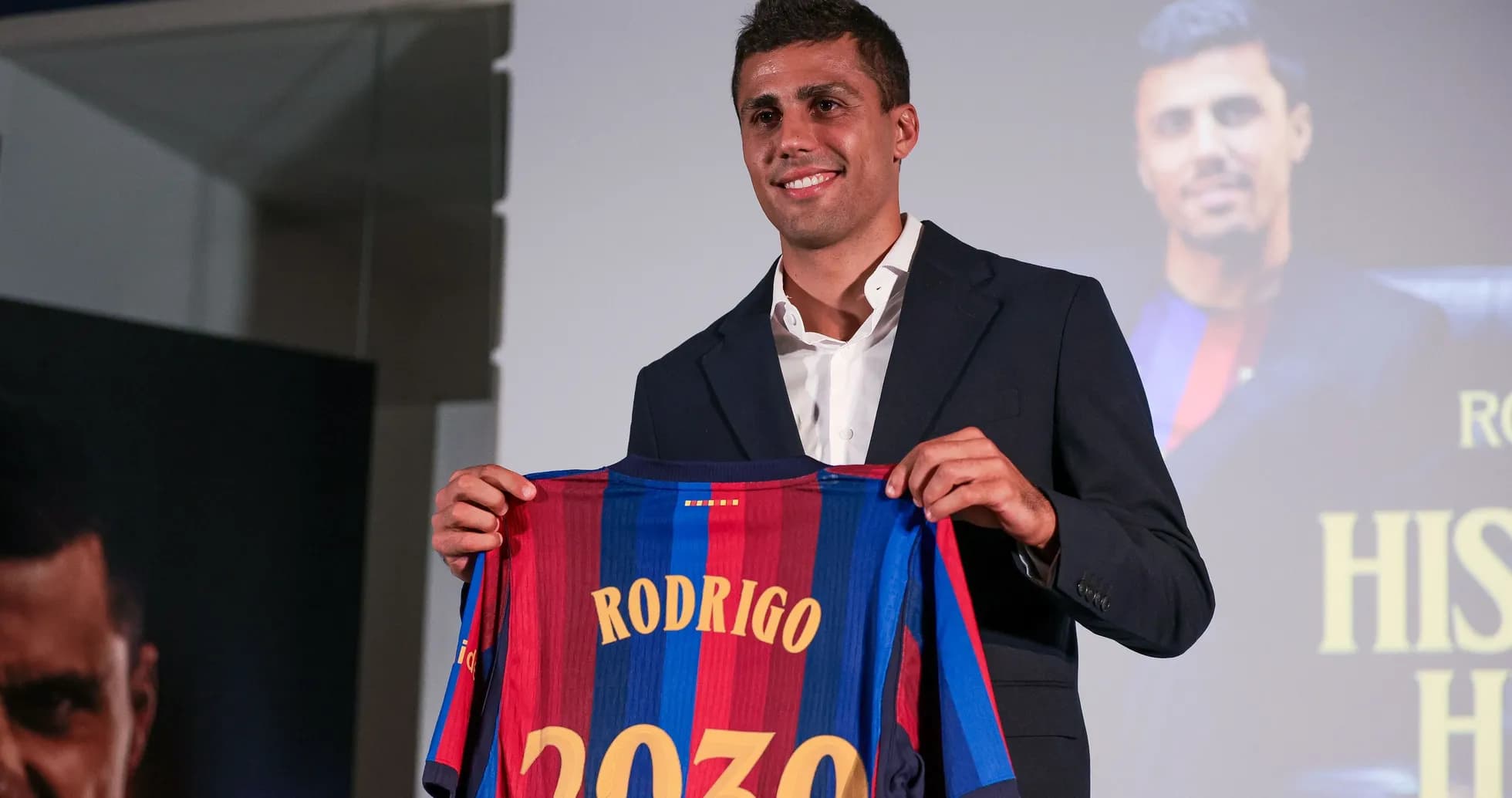 Player presenting Barcelona jersey with name Rodrigo