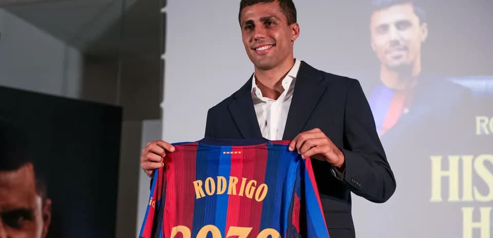 Player presenting Barcelona jersey with name Rodrigo