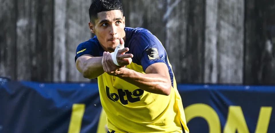 Player training with focused expression and outstretched hands