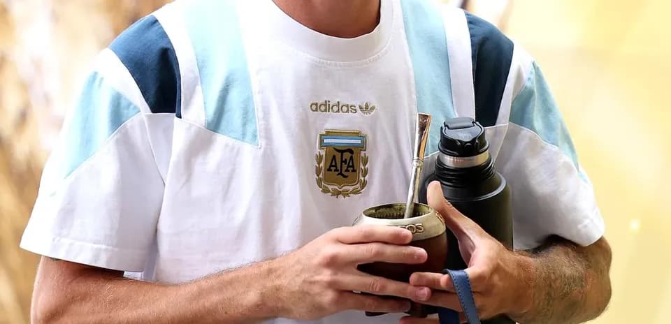 Player holding mate and water bottle, wearing Argentina jersey