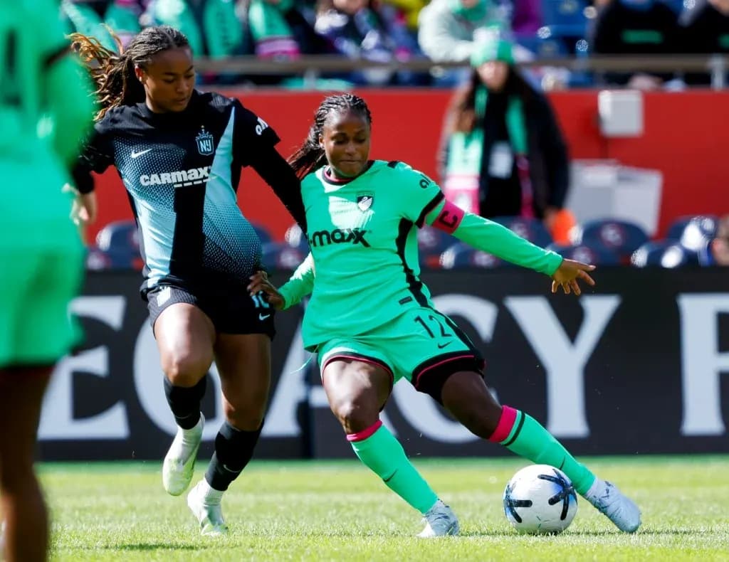 Players competing for the ball in NWSL match