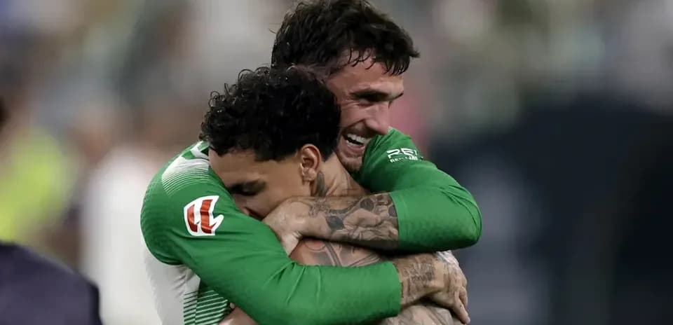 Two soccer players embracing after a match