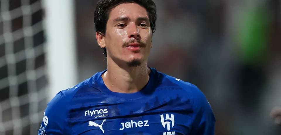 Player in blue jersey after match on field
