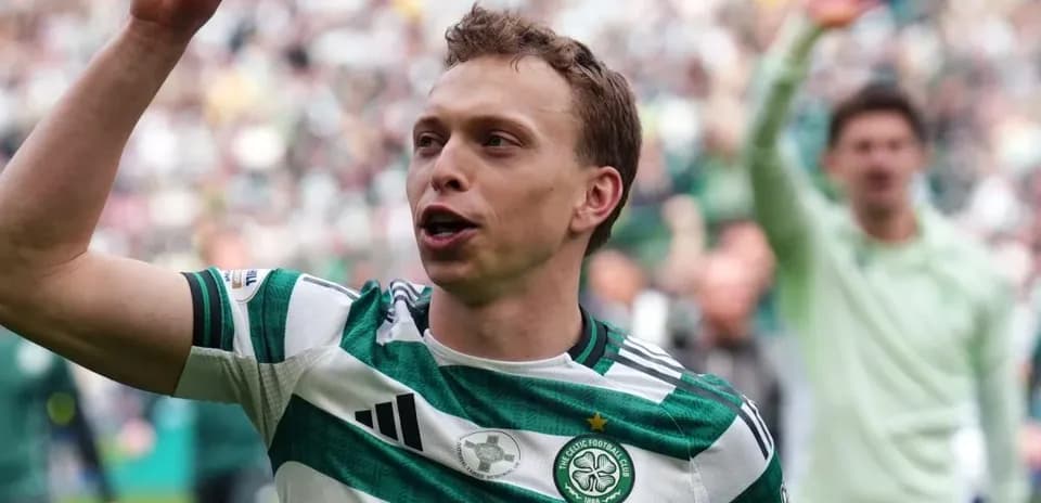 Celtic player celebrating in front of fans