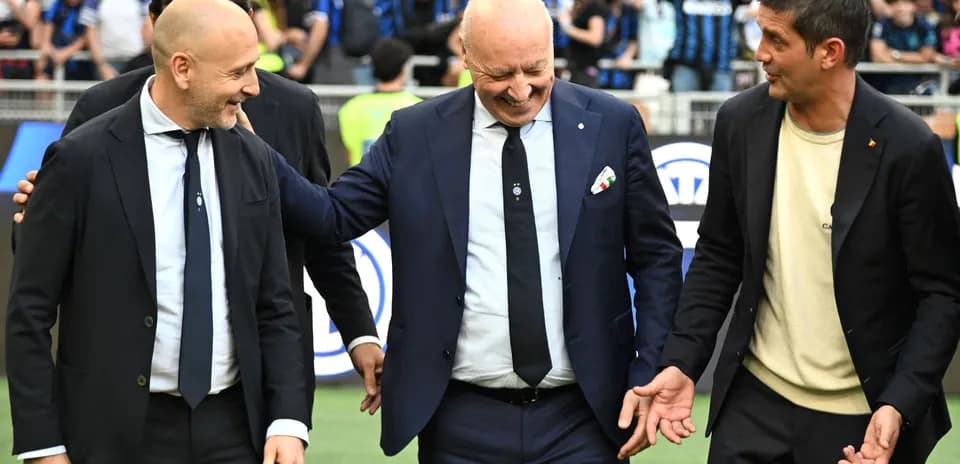 Three men in suits interacting on the field