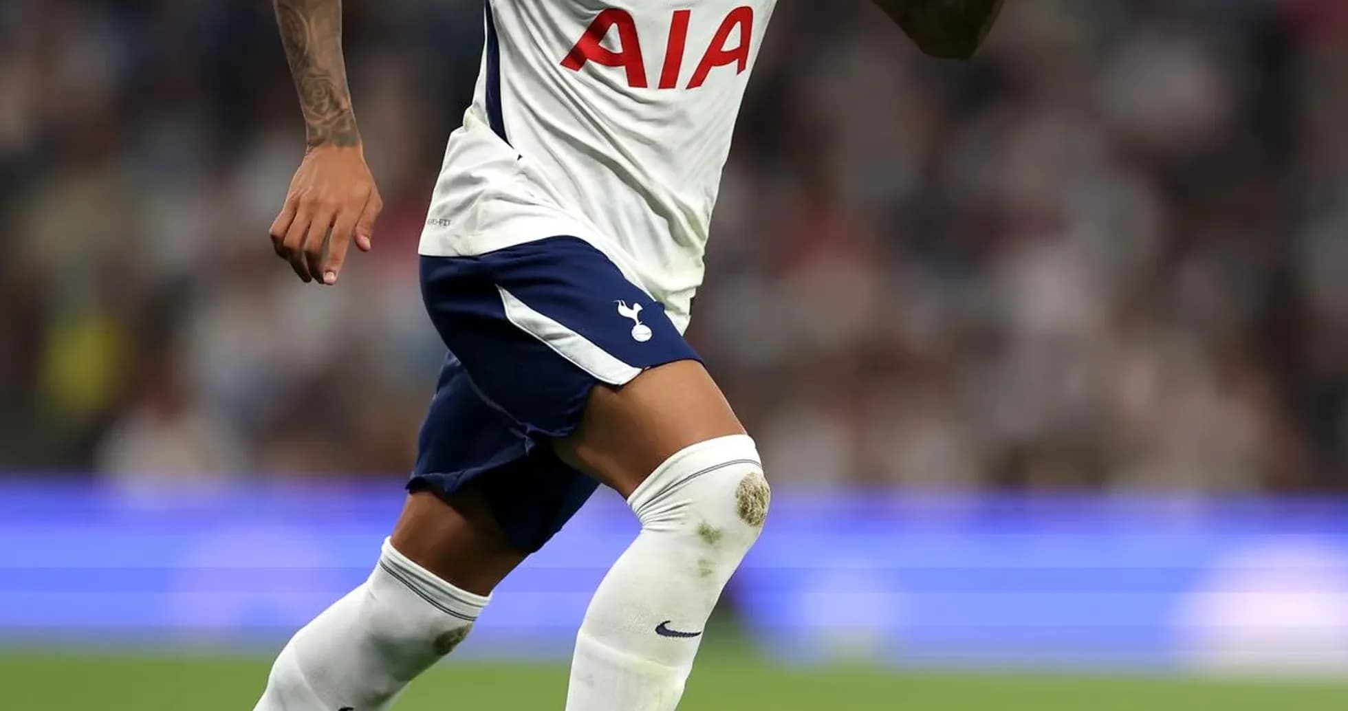 Player running with ball during match for Tottenham