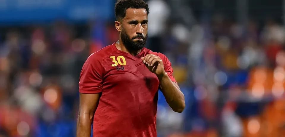 Player in red jersey gesturing on the field