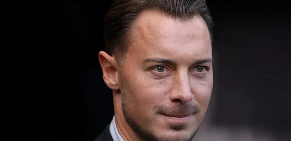 Man in a suit looking towards the camera