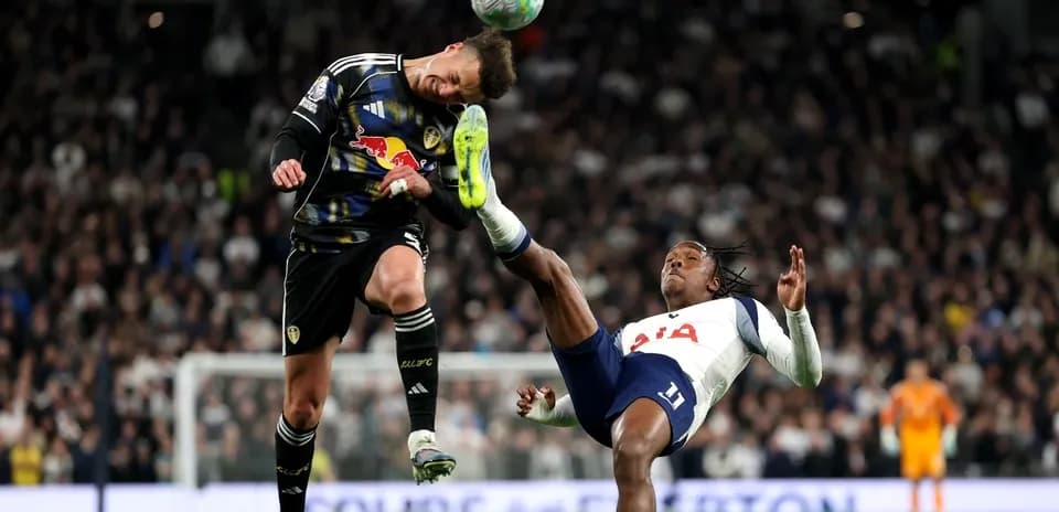 Goalkeeper jumping to avoid opposing player's kick