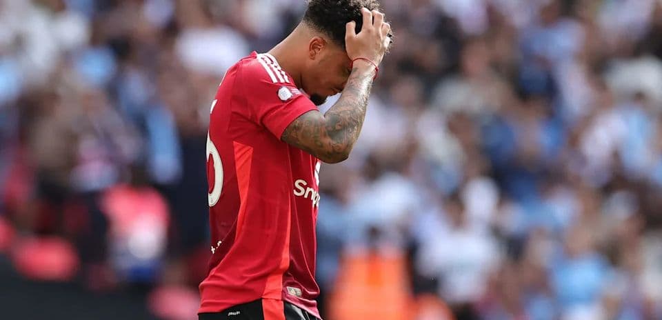 Player in red jersey looks dejected on field