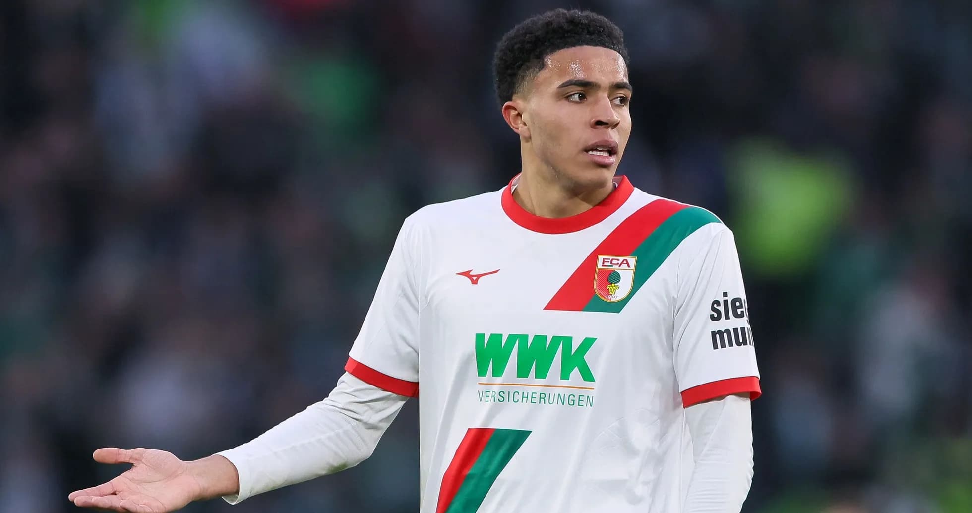 Player in Augsburg jersey gesturing during match