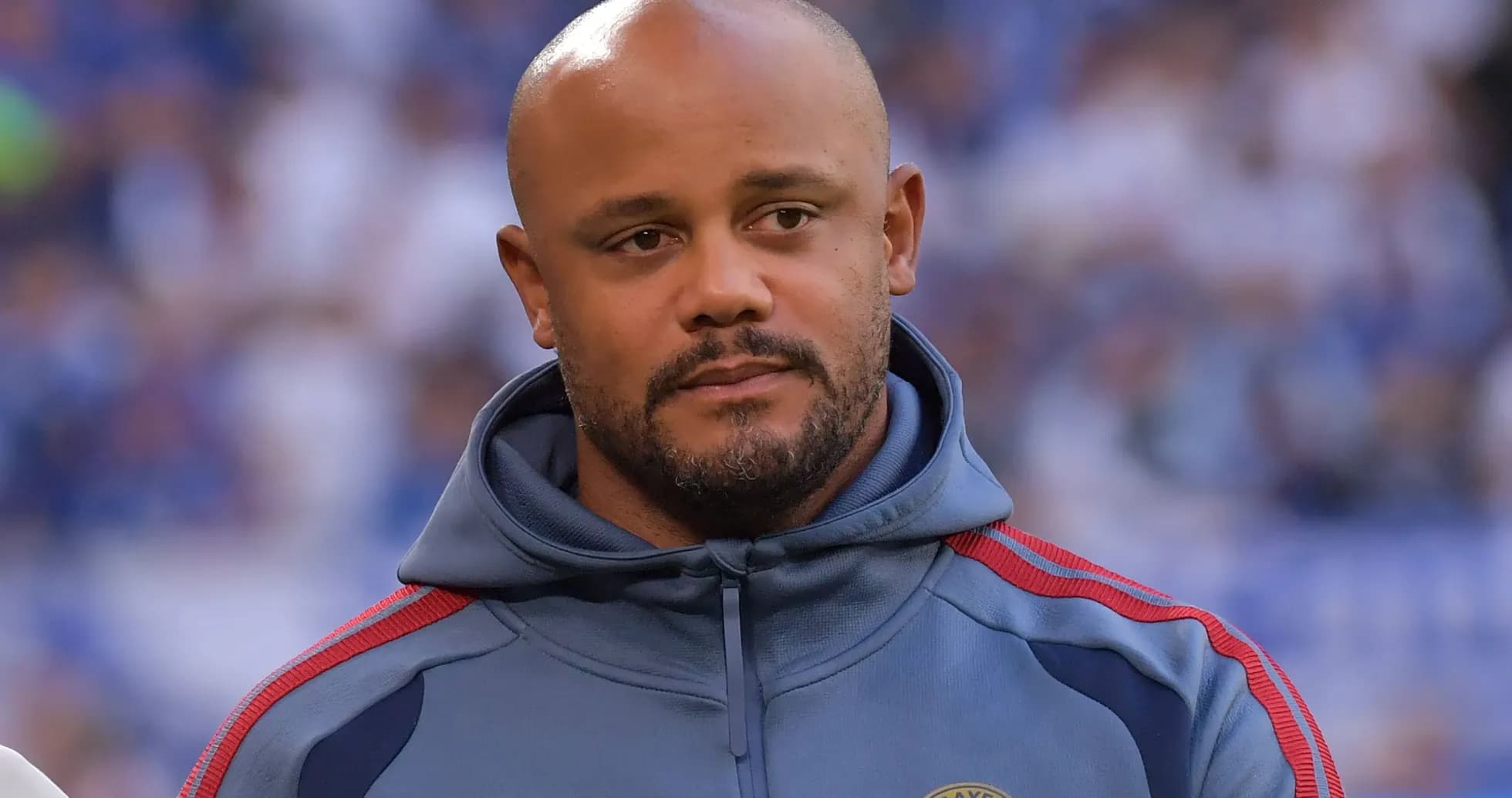 Coach in FC Bayern Munich hoodie on field