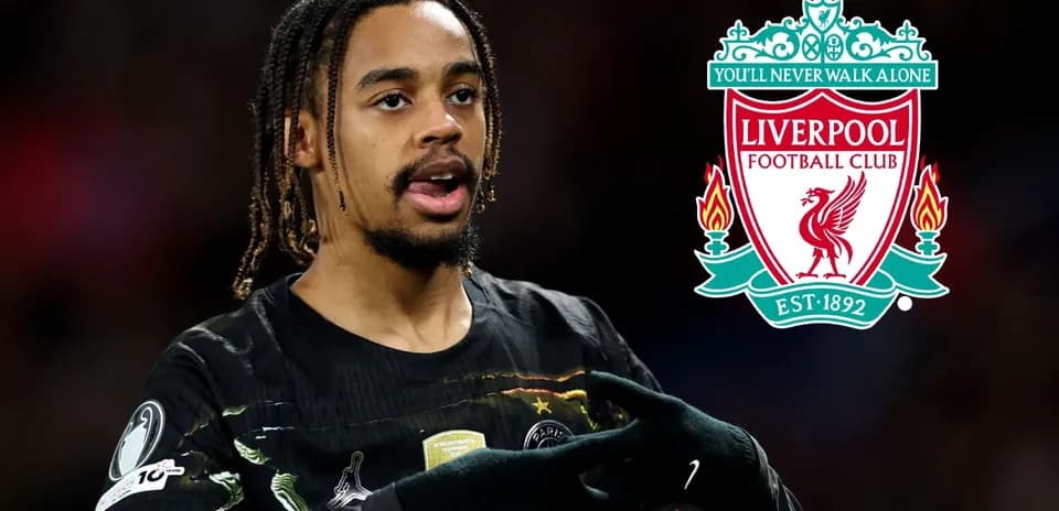 Player gesturing with Liverpool FC logo in background