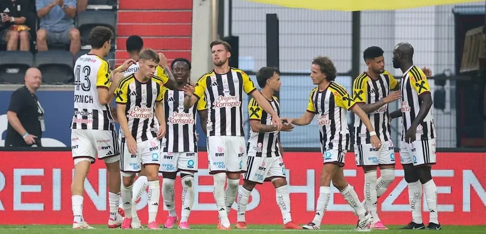 Players celebrating a goal on the field