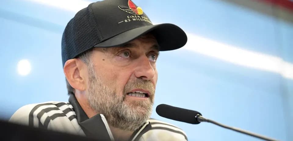 Manager speaking at press conference with microphone