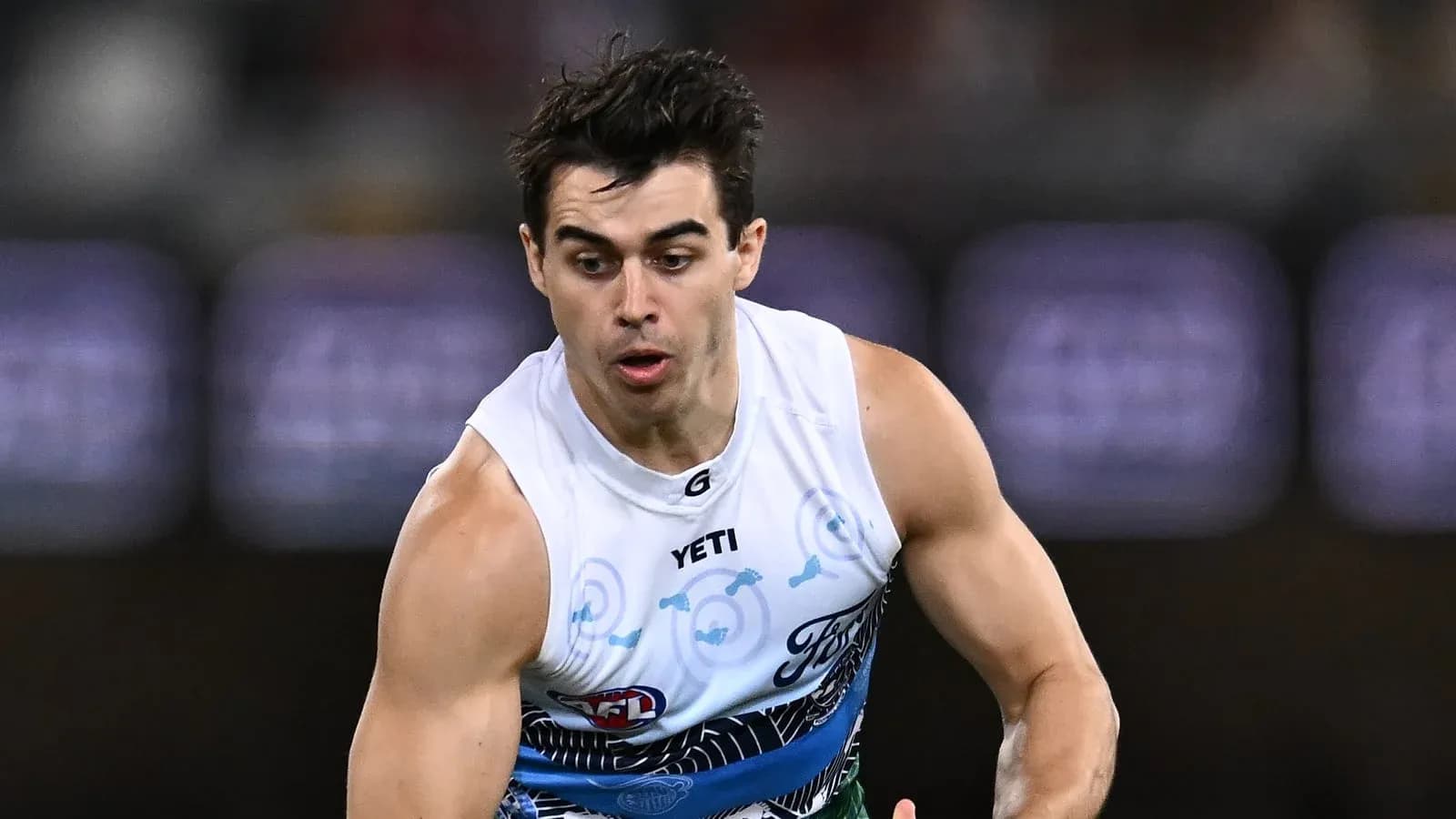 Player running during an AFL match