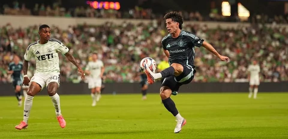 Player kicking ball during Seattle Sounders match