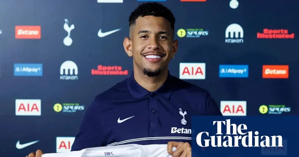 Player holding Tottenham Hotspur shirt at presentation