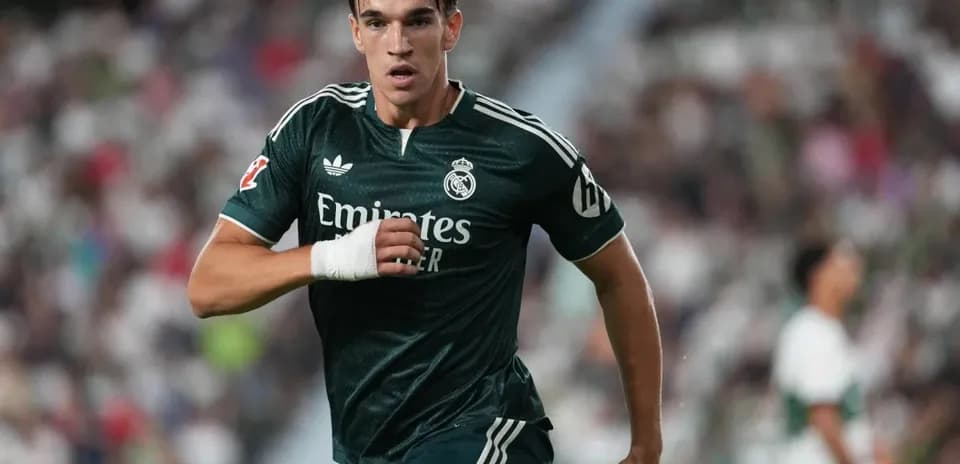 Player sprinting in green Real Madrid kit