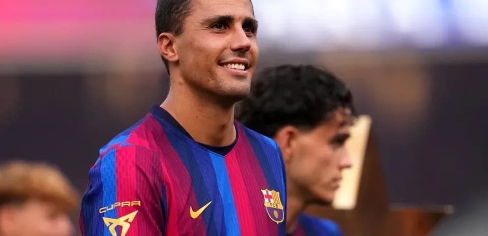Player in Barcelona jersey celebrating with teammates