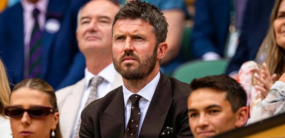 Man in suit watching tennis match at Wimbledon