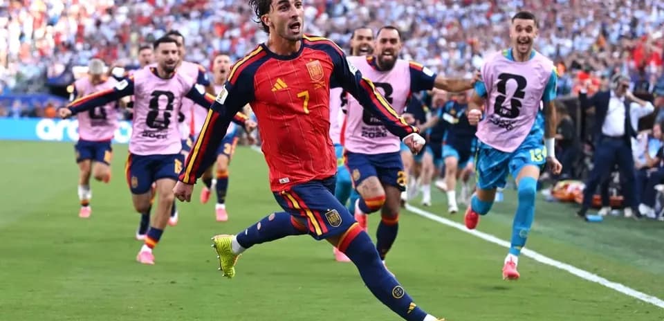 Player celebrating a goal with teammates in stadium