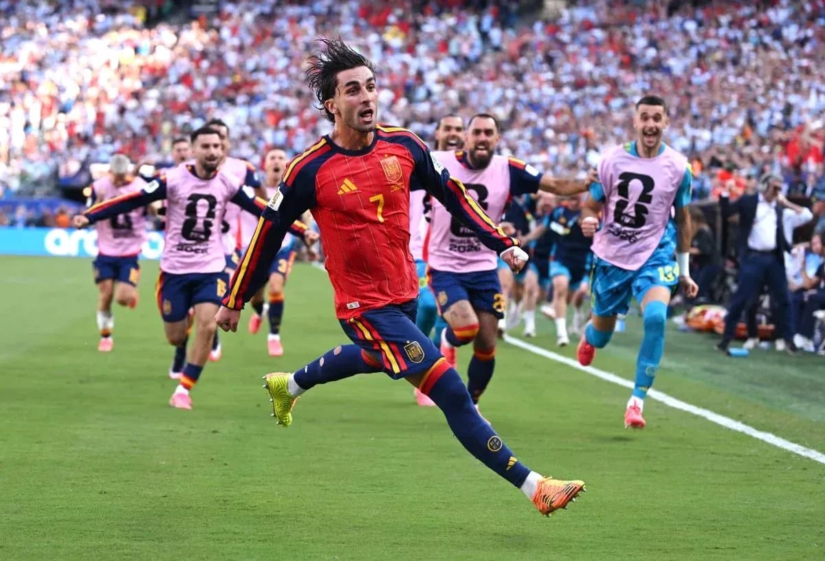 Player celebrating a goal with teammates in stadium