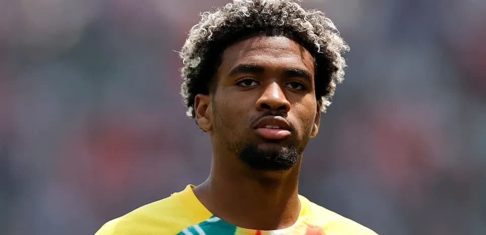 Player with curly hair in colorful training shirt