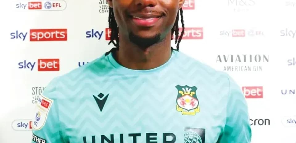 Goalkeeper posing in team kit with sponsor logos