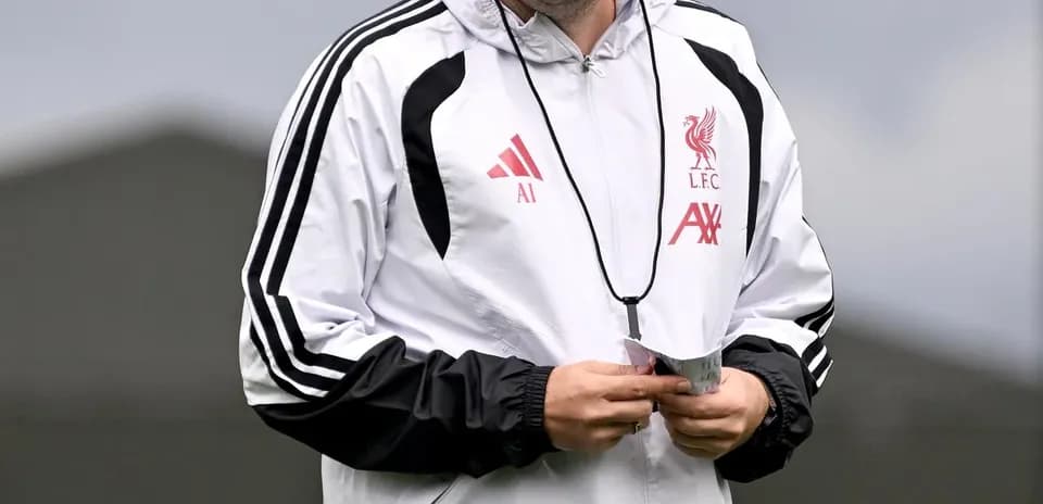 Coach walking during training session at Liverpool