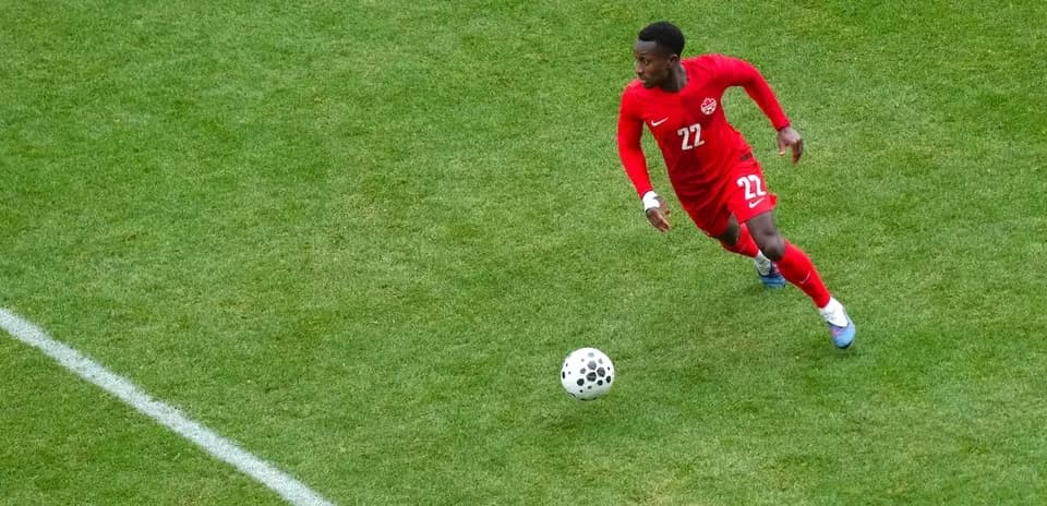 Canadian player running with the ball during match