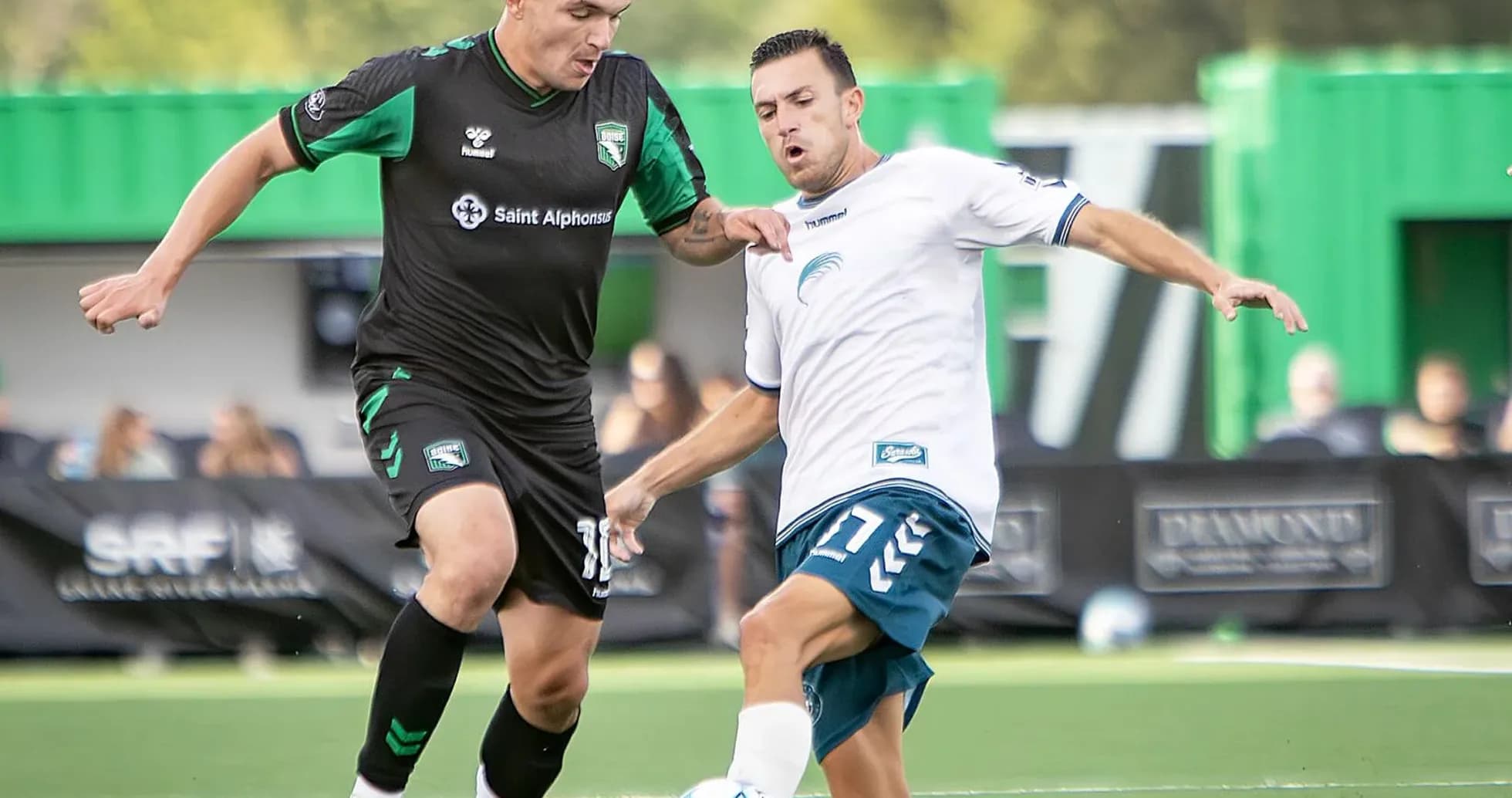 Two players contesting for the ball in match