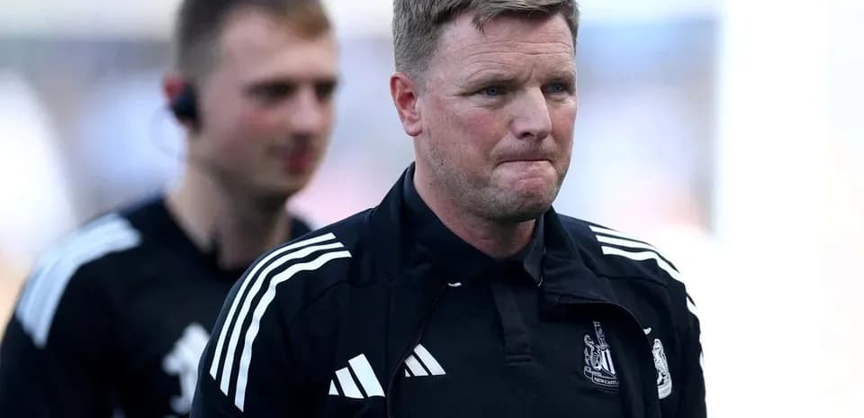 Manager walking off the pitch with staff member