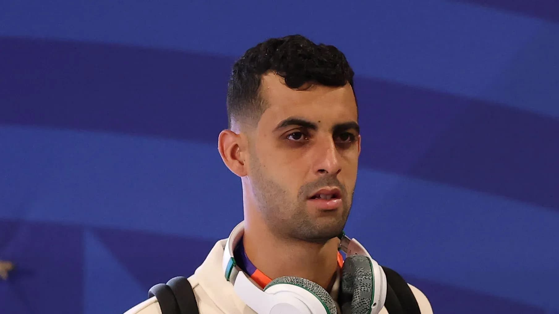 Player wearing headphones, arriving at event venue