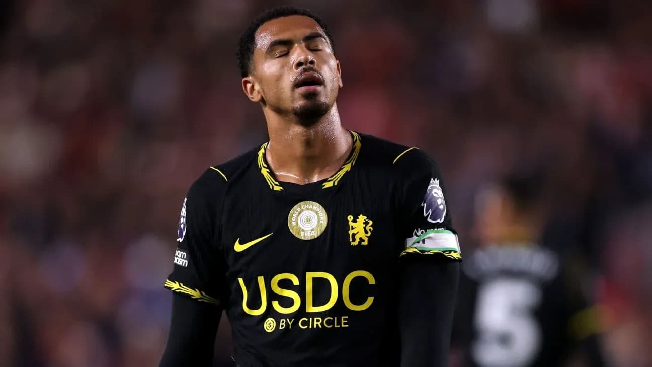 Player in black jersey looking disappointed on field