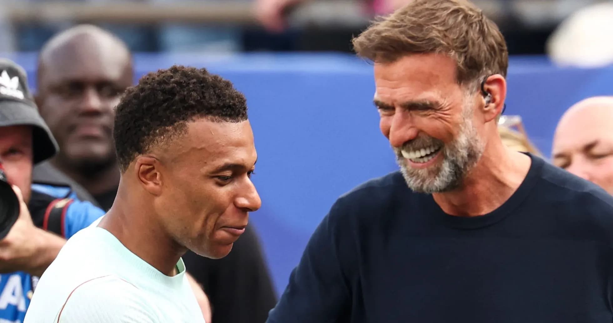 Two men smiling and interacting on the field
