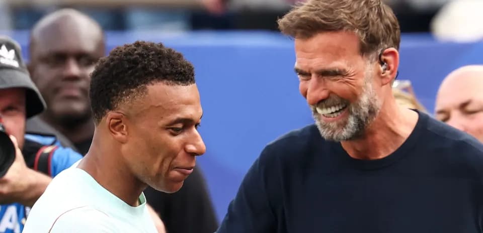 Two men smiling and interacting on the field