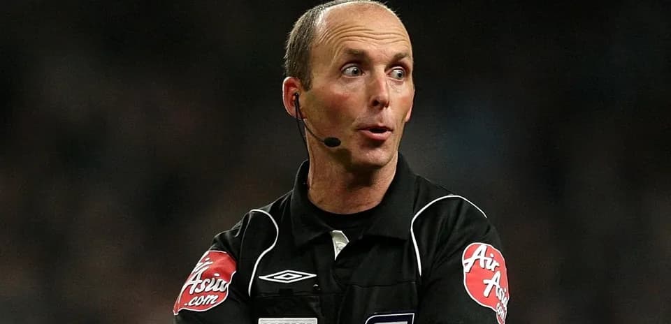 Referee gesturing during a football match