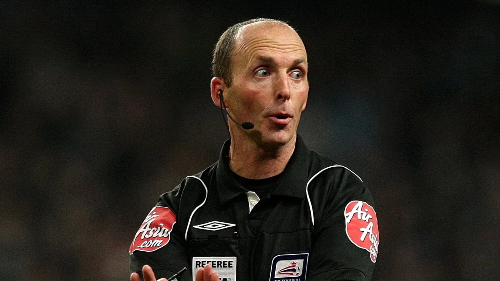 Referee gesturing during a football match