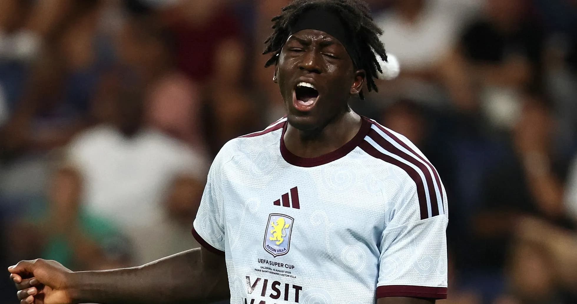 Player in Aston Villa kit reacting during match