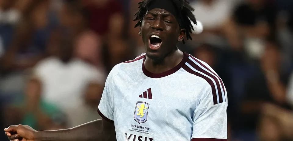 Player in Aston Villa kit reacting during match