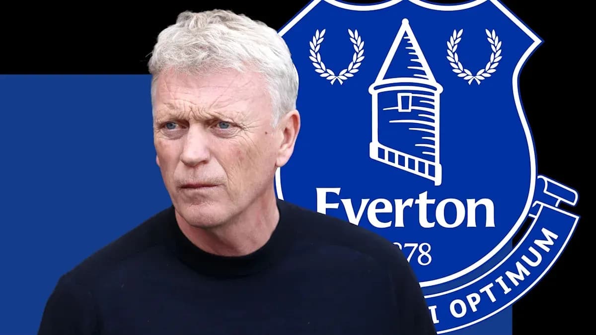 Manager in front of Everton club logo backdrop