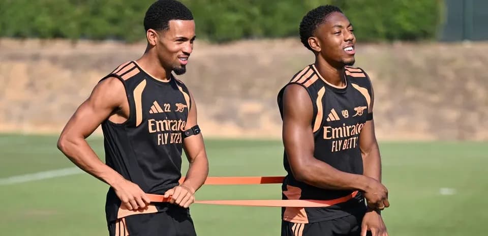 Two players training with resistance bands on pitch