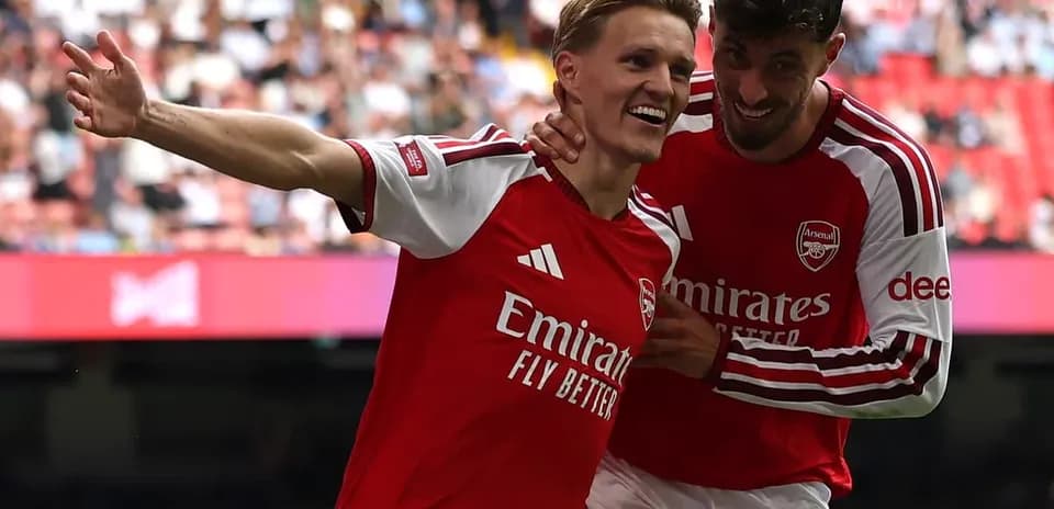 Two Arsenal players celebrating a goal together